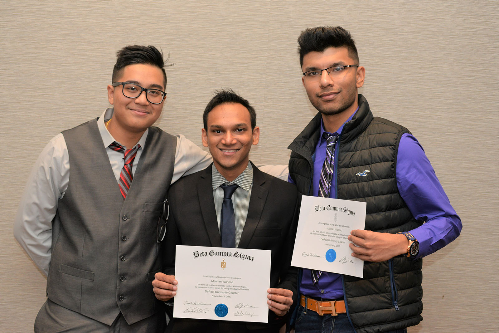 DePaul business students pose with their Beta Gamma Sigma induction certificates.